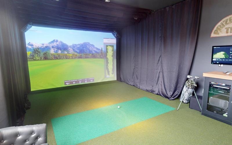 a room with a golf simulator