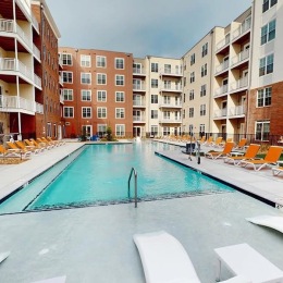 a swimming pool with lounge chairs