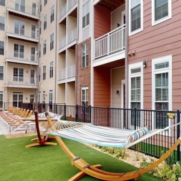 a courtyard with hammocks and chairs