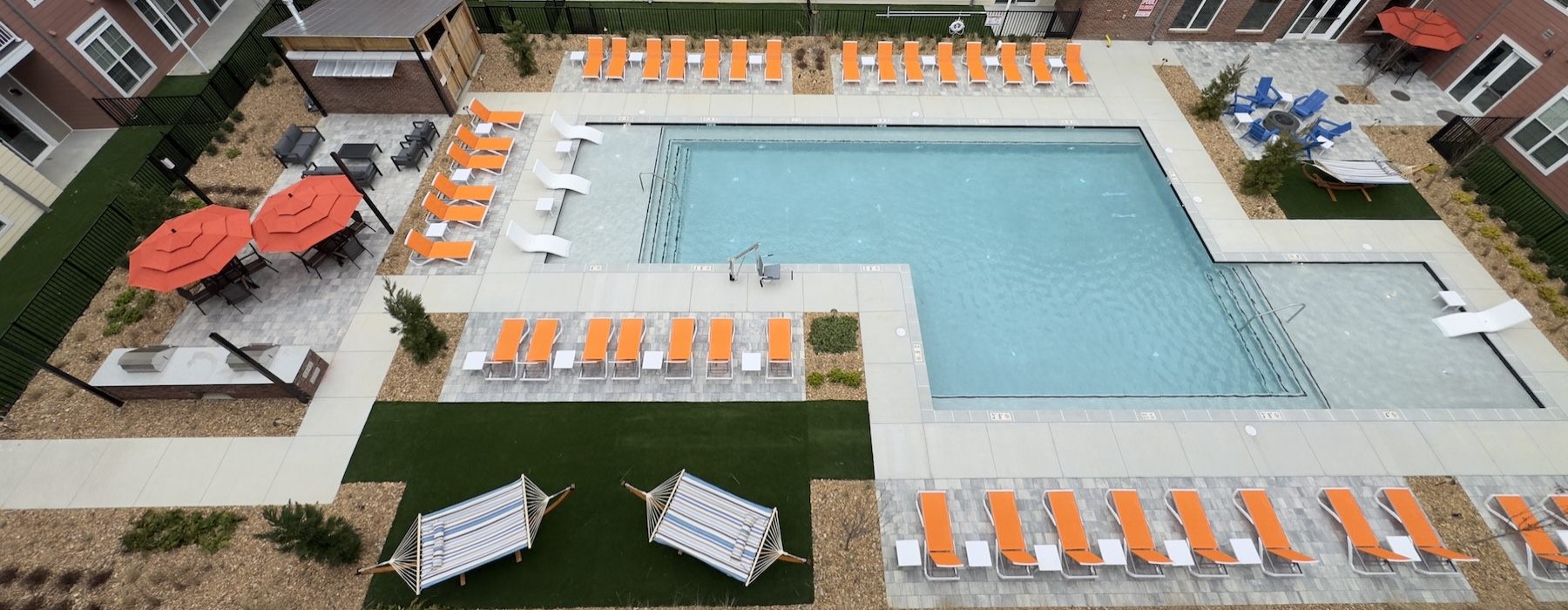 a swimming pool with lounge chairs
