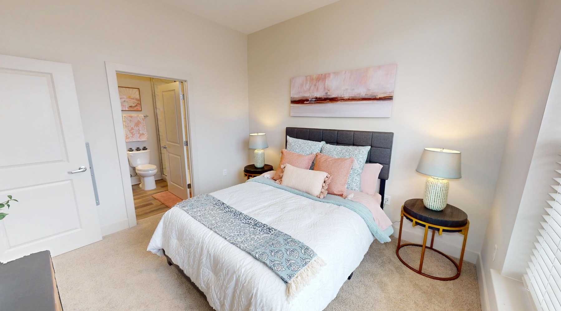 a bedroom with a bed and two nightstands